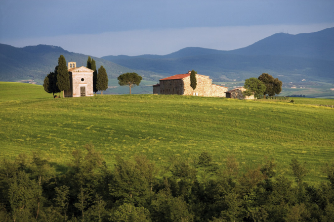 Val d'Orcia Tuscany Landscape with cypress trees and Chapel of Vitaleta with hills in the background