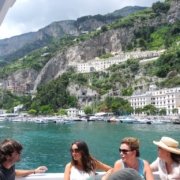 4 people sitting on a boat in the bay of Amalfi