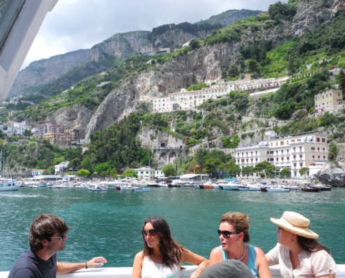4 people sitting on a boat in the bay of Amalfi