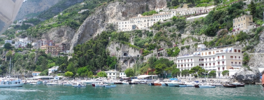 4 people sitting on a boat in the bay of Amalfi