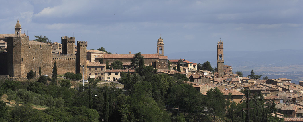 View of Montalcino with cypresse trees and bell towers